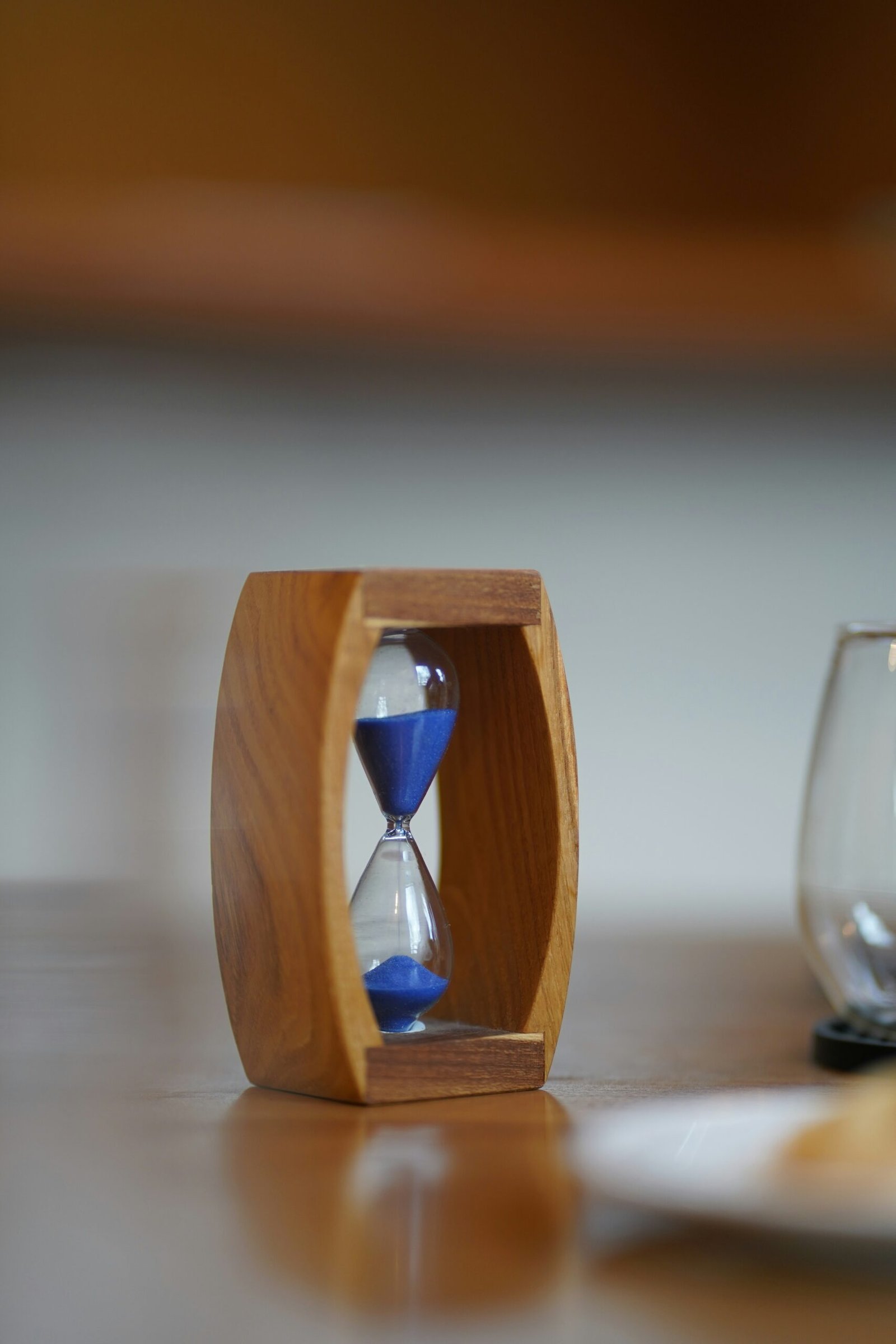 Hourglass with sand running out representing Parkinsons Law and deadlines.