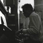 Silhouette of a pianist practicing intensely, illustrating the concept of deliberate practice and the 10,000 hour rule